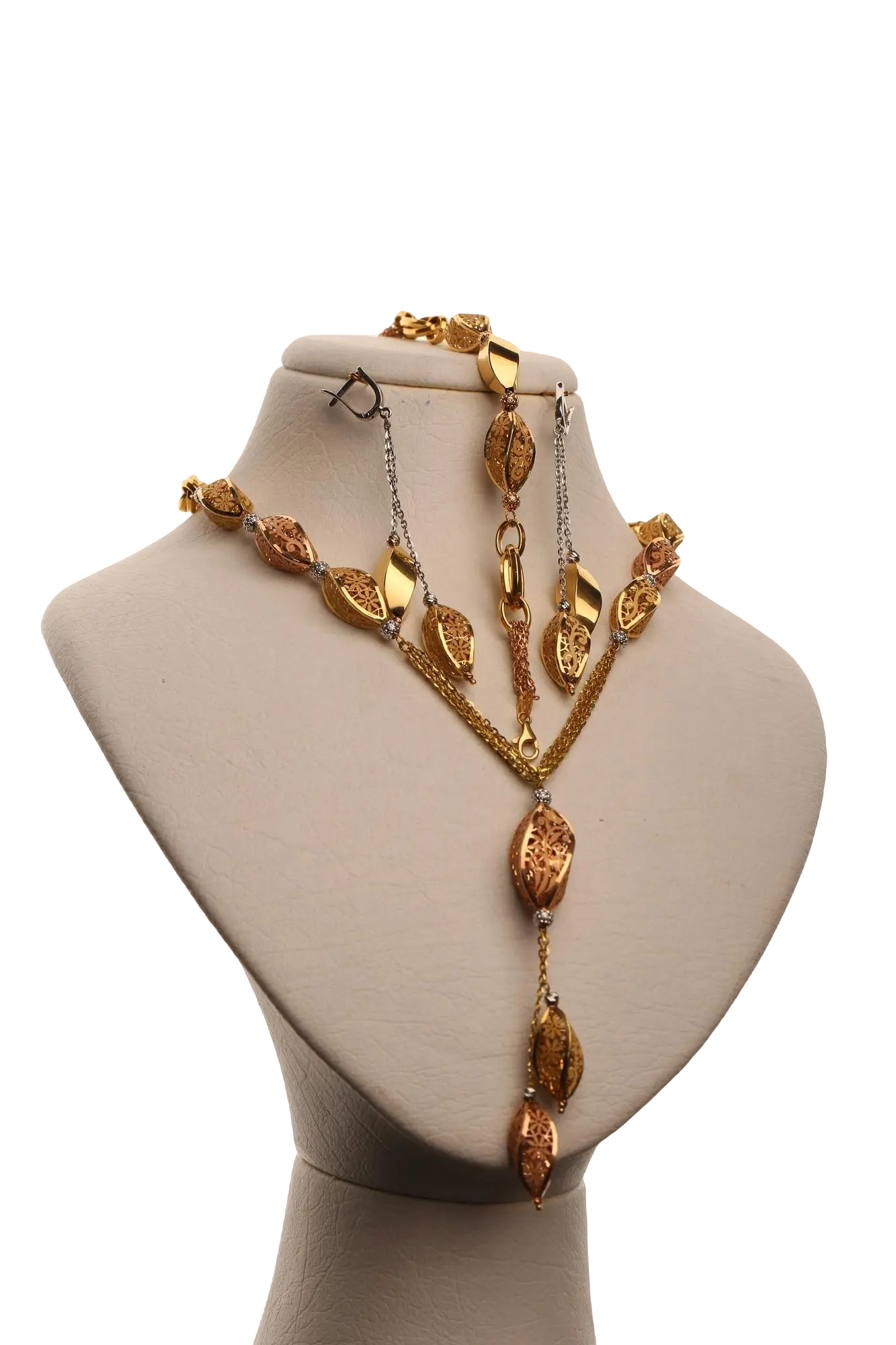 A gold necklace and earring set on a mannequin