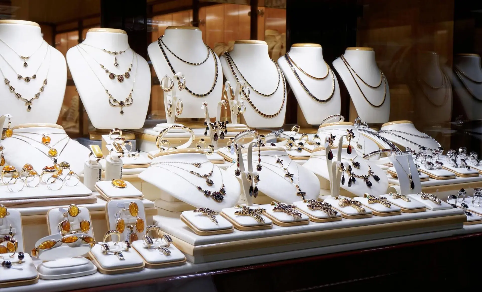A display of necklaces and rings on mannequins